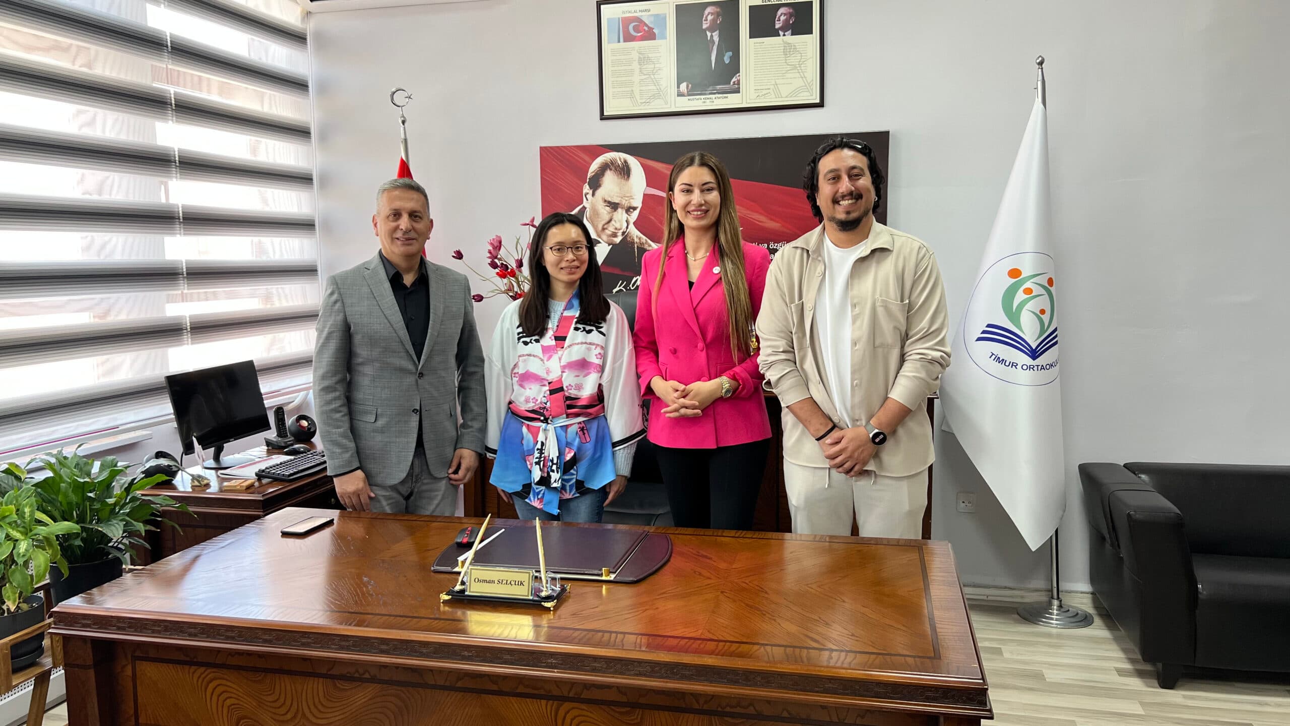 School principal, the Edusama team and a Japanese guest posing in the principal office at Timur Middle School