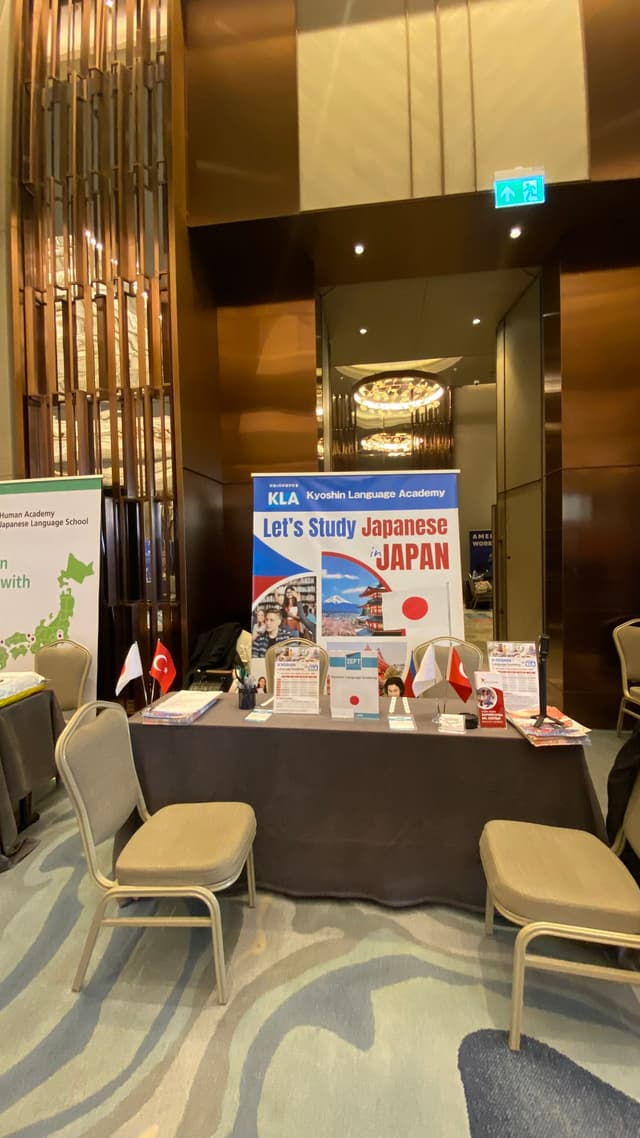 Kyoshin Language Academy booth table at IEFT with Japanese and Turkish flags and brochures