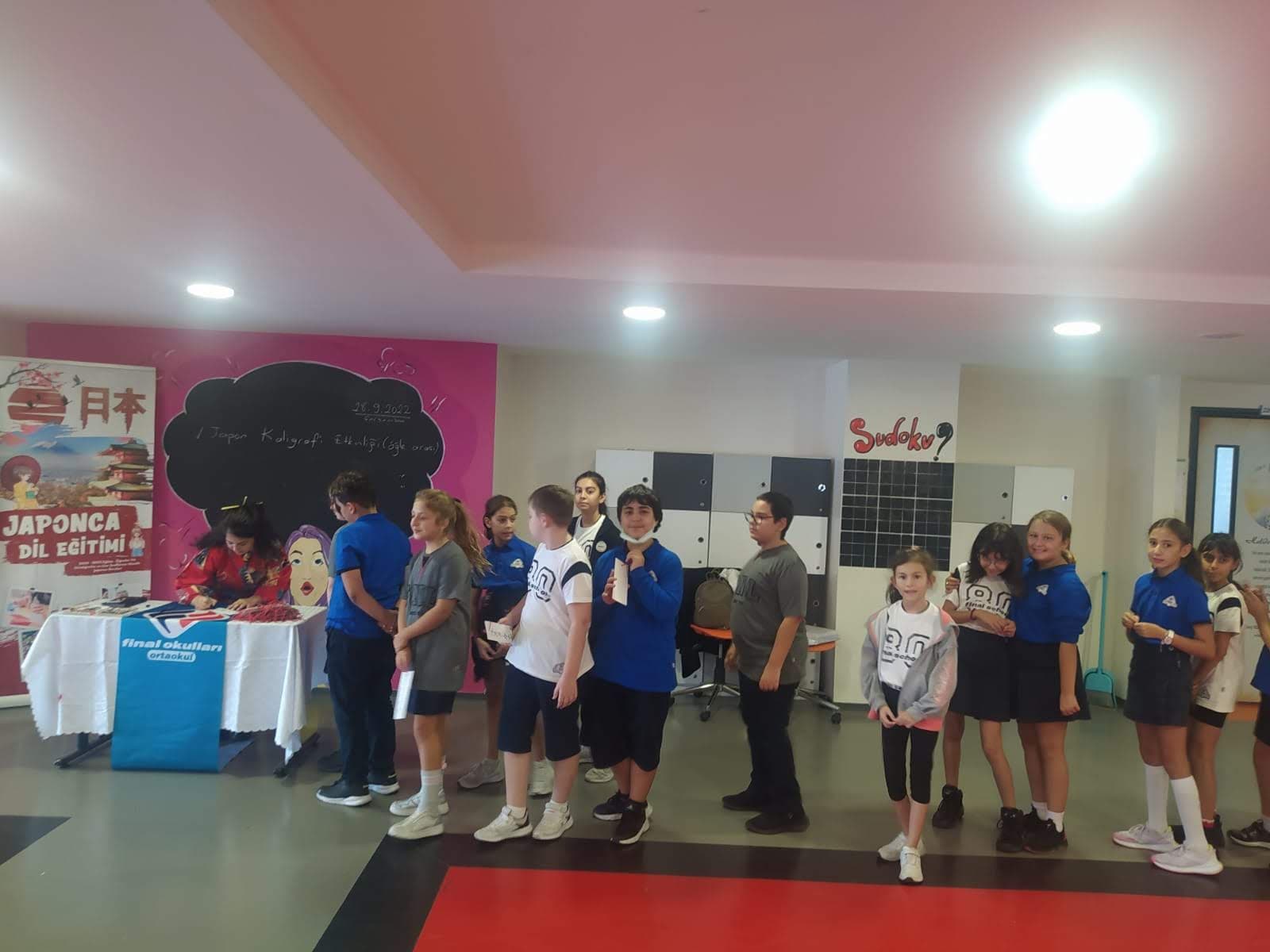 Students lining up at the Japanese language stand at Final Schools