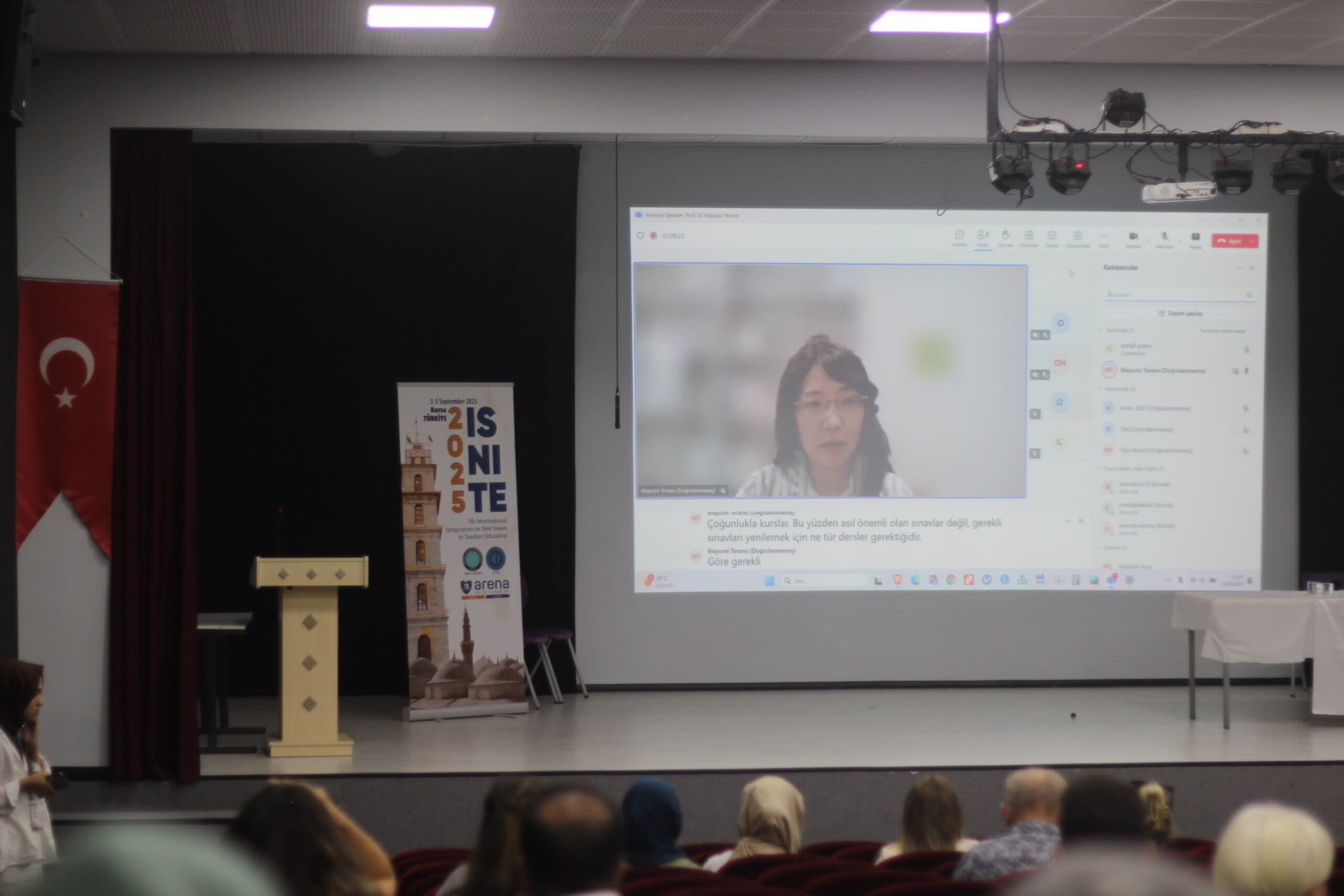Online speaker from Japan shown on the stage screen at the ISNITE 2025 event