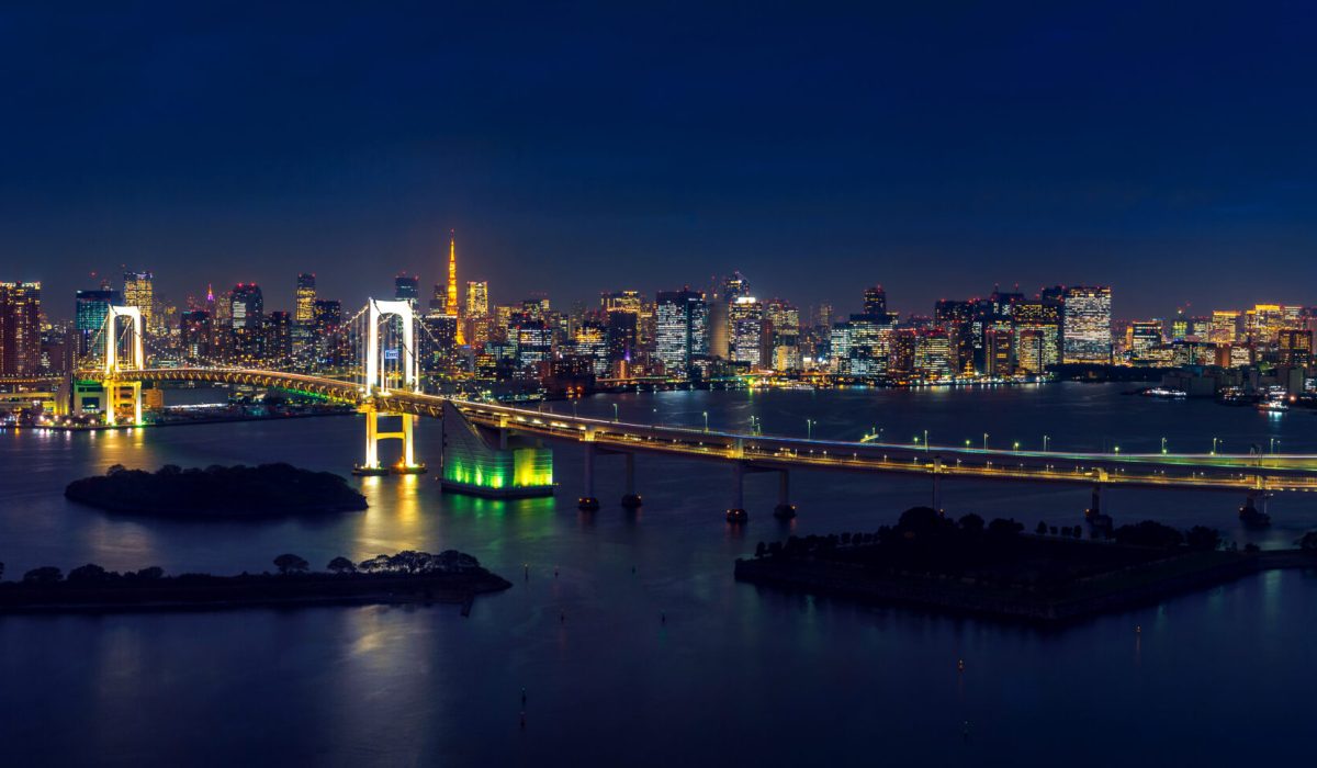 Panorama of tokyo cityscape and rainbow bridge at night.
